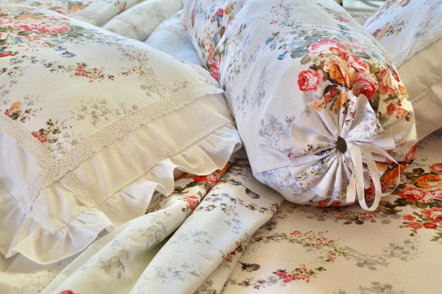 Chăn ga gối cotton cao cấp họa tiết hoa nhí phối hoa hồng,  chăn ga gối Victoria Blue Rose cận cảnh thiết kế vỏ gối nằm bèo nhún xếp ly, phối đồng bộ cùng vỏ gối ôm thắt nơ hai đầu kiểu Pháp
